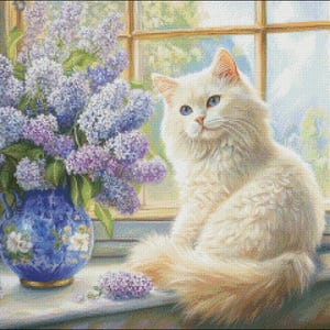 May include: A fluffy white cat with blue eyes sits on a windowsill next to a blue vase filled with purple lilacs. The vase has a floral design. The window has a view of a sunny day.