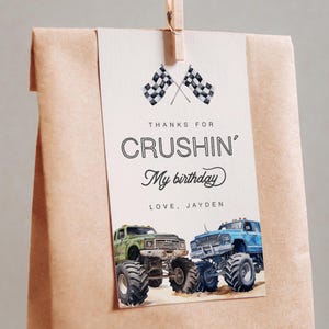May include: A brown paper bag with a thank you tag attached. The tag has a checkered flag design, the text "Thanks for Crushin' My birthday", and two monster trucks.