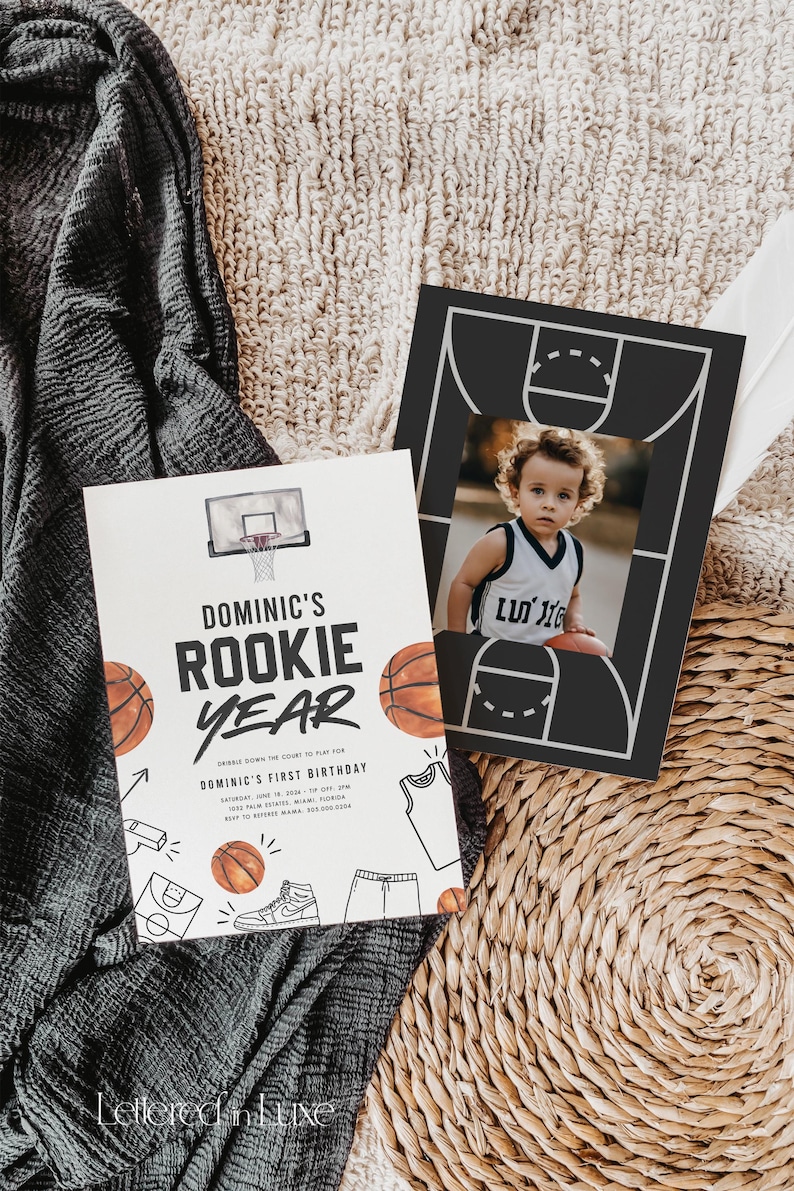 May include: A white invitation with a basketball theme for a first birthday party. The invitation features a basketball hoop, basketballs, and the text "Dominic's Rookie Year".