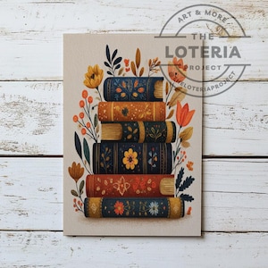 May include: A print featuring a stack of six decorative books with floral and leaf designs. The books are in shades of blue, orange, and red, with gold accents. The text "The Loteria Project" is in the upper right corner.