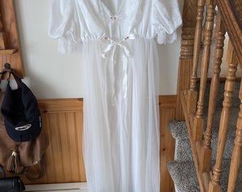 May include: White sheer robe with lace trim and a satin tie. The robe has a V-neckline and is made of a lightweight fabric.