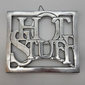 Vintage “Hot Stuff” Metal Trivet – Retro Kitchen Hot Plate Approx 6.5″ × 7.5″, Collectible Wall or Table Decor