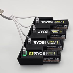 May include: A black Ryobi battery charging station with four USB lithium batteries. The batteries are labelled with "USB Lithium" and "2.0Ah 7.2Wh". A white USB cable is connected to the charging station.