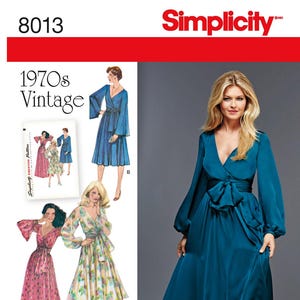 May include: Simplicity 8013 sewing pattern featuring 1970s vintage dresses. The image shows a woman in a teal wrap dress with long sleeves and a bow. Other dress designs include a pink floral dress and a blue dress.