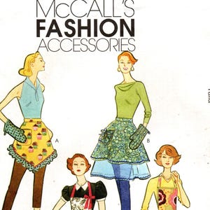 May include: Vintage McCall's Fashion Accessories sewing pattern M5825. The pattern features illustrations of aprons and oven mitts in various styles. The aprons have floral, cupcake, and patterned designs. The text "MCCALL'S FASHION ACCESSORIES" is at the top.