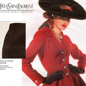 May include: A red blazer with a fitted waist and a peplum hem. The blazer has a button closure and gold buttons. The model is wearing black gloves and a black skirt. The image also includes a black skirt and the text "Superb Pocket Details" and "Des détails superbes sur les poches".