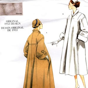 May include: A Vogue Vintage Model sewing pattern envelope for an original 1953 design, labeled V1083. The illustration displays two variations of a long coat with a wide collar and cuffed sleeves, shown in tan and white, with a small hat.