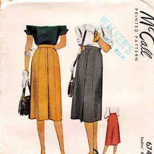 May include: A McCall printed pattern envelope for a skirt, number 6746, featuring illustrations of three skirt variations in yellow, dark gray, and red. The text includes McCall, Walker's Calif, 6746, and Waist 26. The design shows a high-waisted skirt.