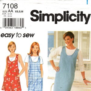 May include: Simplicity sewing pattern with three dress designs. The dresses include a red floral print, a blue and white plaid, and a solid light blue dress. The pattern includes sizes XS, S, and M.