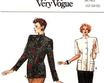 May include: A vintage sewing pattern from Very Easy Very Vogue, featuring two women's fashion designs. One model wears a floral print jacket and tan pants, the other a white jacket and black skirt. The pattern number is 9482, sizes 12-14-16.