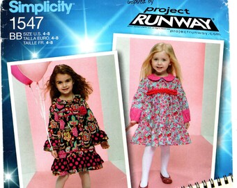May include: A sewing pattern for a girl's dress. The pattern is for sizes 4-8 and is inspired by Project Runway. The pattern includes a variety of different styles, including a floral print dress, a polka dot dress, and a plaid dress.