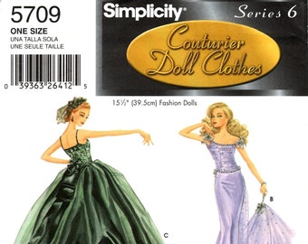 May include: A sewing pattern for doll clothes, featuring three different masquerade ball gowns. The gowns are a green ball gown, a lavender ball gown, and a black and gold ball gown. The pattern is for 15 1/2 inch (39.5 cm) fashion dolls. The pattern is titled "Masquerade" and is by Patti Wagner Miller.