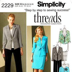 May include: A sewing pattern for a jacket and skirt set. The pattern includes three different views: a black and white patterned jacket with black pants, a turquoise jacket with a turquoise skirt, and a turquoise jacket with a turquoise skirt and a black flower embellishment.