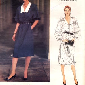 May include: A Vogue Patterns Paris Original sewing pattern envelope 1140 by Givenchy. The front displays a photograph of a dark blue dress with a white collar and a belt, alongside a fashion illustration of a white dress with polka dots.