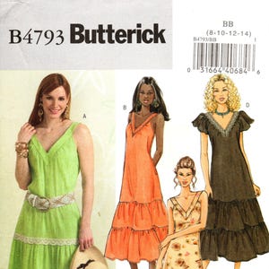 May include: Butterick B4793 sewing pattern featuring four different dress designs. The dresses include a green sleeveless dress with a tiered skirt, an orange dress, a floral print dress, and a black dress with flutter sleeves. The pattern includes sizes 8-14.