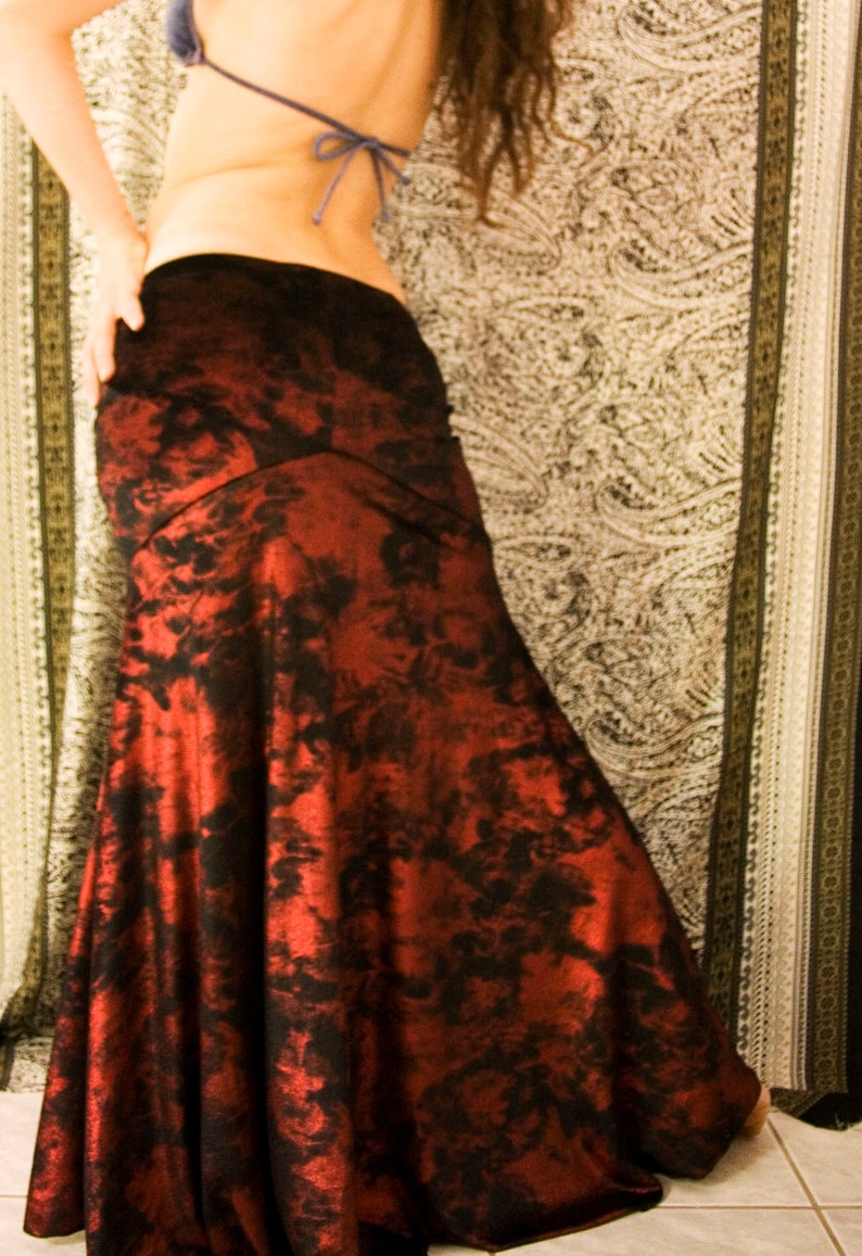 May include: A red and black patterned maxi skirt with a mermaid style hem.