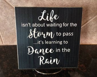 Life Isn't about Waiting for the Storm to Pass Wood Sign