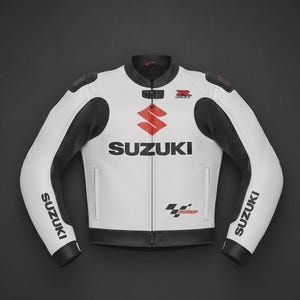 May include: A white and black motorcycle jacket featuring the red Suzuki logo on the chest, the word SUZUKI in black on the sleeves and chest, a small red R logo, and a checkered flag graphic with the text MotoGP on the lower front panel.
