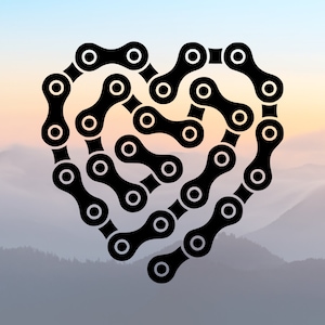 May include: A black bicycle chain arranged in the shape of a heart. The chain is made of metal links and is a common part of a bicycle.