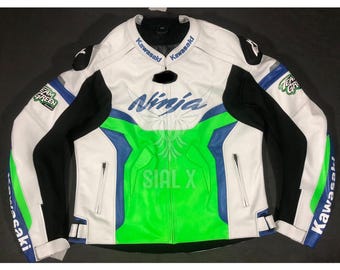 May include: White leather motorcycle jacket with green and blue accents. The jacket has "Ninja" and "Kawasaki" logos on the front and "Team Green" on the sleeves.