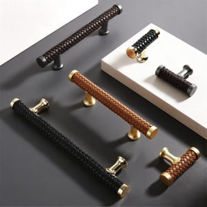 May include: An assortment of decorative door and cabinet handles. The handles feature a braided leather design in various colors, including black, brown, and tan. The metal hardware has a gold or dark gray finish.