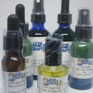 May include: Five glass bottles with dropper tops and spray tops. The bottles are filled with different colored liquids. The bottles are labeled "Little Pamel's Crafts" and "Love Spell Hair, Skin, & Nails Oil". The bottles are 0.5 fluid ounces (14.78 ml).