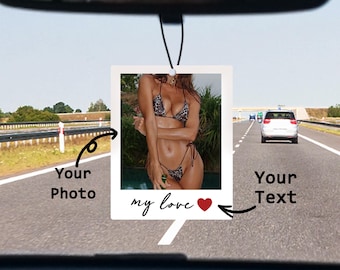 May include: A white car air freshener with a photo of a woman in a bikini. The photo is in a white frame with a red heart and the text "my love".
