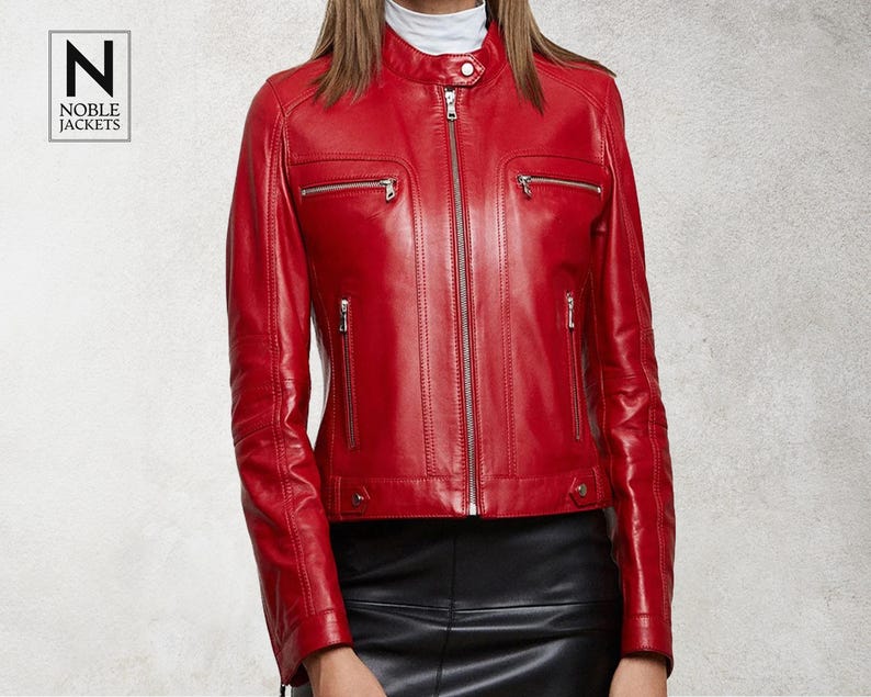 May include: A red leather biker jacket with a zip fastening and multiple pockets. The jacket has a stand-up collar and a slim fit.