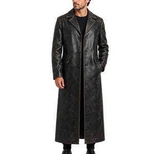 May include: A full-length black leather trench coat featuring a distressed finish, a wide notched collar, and a three-button front closure. The coat includes two side flap pockets and long sleeves, providing a structured silhouette with visible seams.
