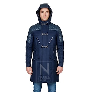 May include: A navy blue hooded coat with quilted shoulder patches and silver-tone hardware. The coat features a zip closure, multiple pockets, and a belt detail at the waist. The coat is worn with blue jeans.