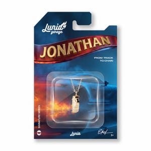 May include: A gold-colored pendant necklace on a gold chain, packaged on a blue and red card. The card reads "JONATHAN" and "FROM TRACK TO CHAIN". The brand name "Lurid garage" is visible.