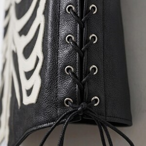 Handmade Raffania skeleton leather vest for men featuring a white ribcage bone design on premium black genuine cowhide leather.