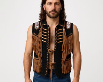 May include: A black sleeveless vest featuring long tan fringe detailing on the front, two front pockets, and two cord closures. The shoulders are accented with white, black, and maroon geometric embroidery and tan piping along the edges.