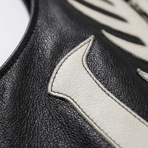 Handmade Raffania skeleton leather vest for men featuring a white ribcage bone design on premium black genuine cowhide leather.
