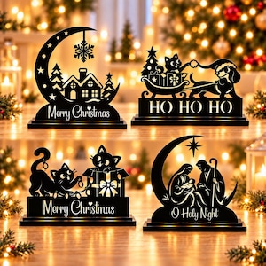 May include: Four black silhouette tabletop decorations. One shows a crescent moon, house, and snowflake with Merry Christmas. One shows a cat and dog in a sleigh with HO HO HO. One shows cats with a gift and Merry Christmas. One shows a nativity scene with O Holy Night.