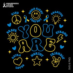 May include: Black graphic with the words "YOU ARE" in yellow and blue, surrounded by positive words and symbols like a peace sign, heart, star, and lightning bolt. The image also includes the text "SVG & PNG".