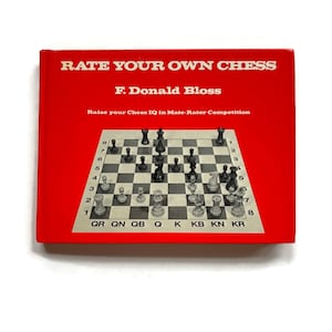 May include: A red book titled "Rate Your Own Chess" by F. Donald Bloss. The book cover features a chessboard with pieces in a mid-game position. The text "Raise your Chess IQ in Mate-Rater Competition" is printed below the title.