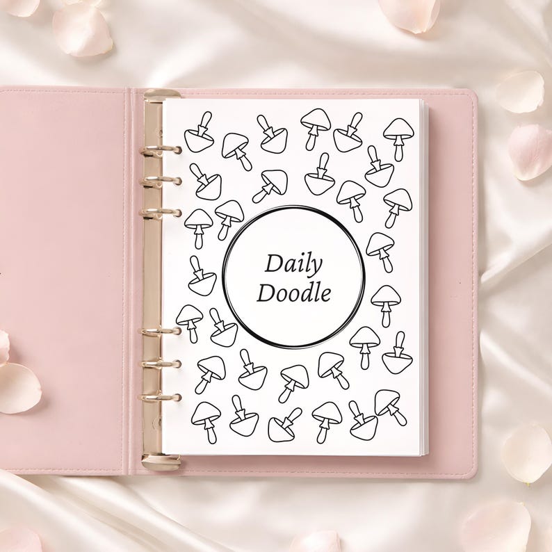May include: A pink binder with a white page featuring a black and white mushroom doodle pattern. The page has a circular design with the words "Daily Doodle" in the center. The binder is open, revealing the pages.