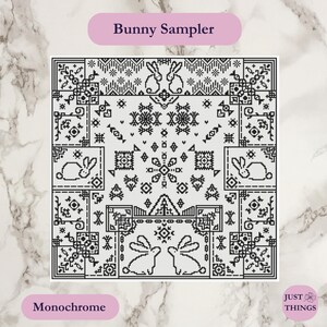 May include: Monochrome cross-stitch pattern featuring a geometric design with bunny motifs. The text "Bunny Sampler" is at the top, and "Monochrome" is at the bottom. The design is black and white, with a marble background.