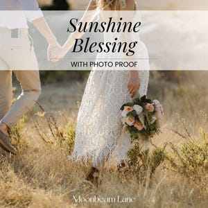 May include: A white lace dress with a fringed hem and a bouquet of pink and white flowers, paired with beige trousers and suspenders. The text Sunshine Blessing WITH PHOTO PROOF and Moonbeam Lane is overlaid on the image of the two individuals.