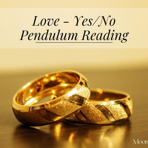 May include: Two gold rings with textured surfaces are displayed. The rings are set against a blurred background with the text "Love - Yes/No Pendulum Reading" at the top. The rings are on a reflective surface.