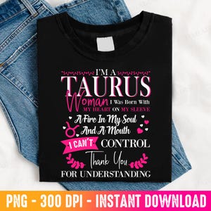 May include: Black t-shirt with the text "I'M A TAURUS Woman I Was Born With My Heart On My Sleeve A Fire In My Soul And A Mouth I CAN'T CONTROL Thank You FOR UNDERSTANDING". The shirt is folded on top of blue jeans.