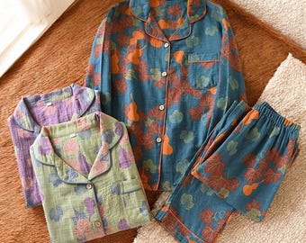 May include: Three sets of pajamas with a blue, green, and purple background. Each set features a leaf and gourd print in orange and brown.
