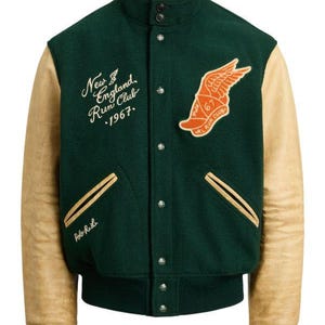 May include: A green and tan varsity jacket with a button-up front. The jacket features tan leather sleeves, a ribbed hem and cuffs, and a high collar. The front has the text "New England Run Club 1967" and a winged logo.
