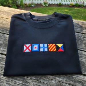 May include: A set of three ceramic mugs with a speckled, matte finish. Each mug features a different color: light blue, cream, and gray. The mugs have a simple, modern design and a comfortable handle.