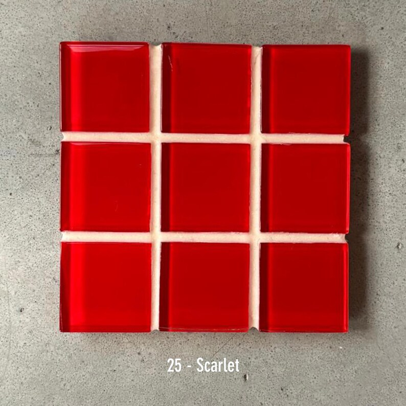 May include: A square mosaic tile sheet featuring nine glossy, square red tiles. The tiles are arranged in a 3x3 grid, separated by white grout. The text "25 - Scarlet" is at the bottom.