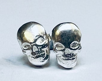 sterling silver handmade skull stud earrings.