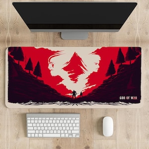 Peut inclure: Un tapis de souris de jeu rouge et blanc avec une image stylisée de deux personnages debout dans une vallée de montagne. Le texte "GOD OF WAR" est dans le coin inférieur droit.
