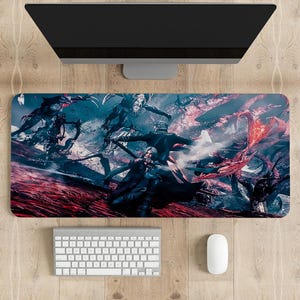 May include: A rectangular mouse mat with a dynamic illustration of figures in dark clothing, set against a backdrop of red and blue hues. A keyboard, mouse, and computer monitor are visible above and below the mouse mat.
