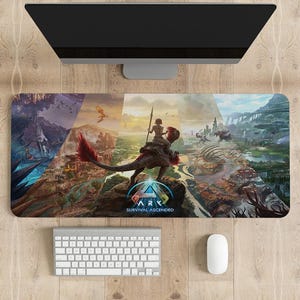 May include: A colourful gaming mouse mat featuring a collage of scenes from the video game "ARK: Survival Ascended". The image includes a woman riding a dinosaur, a variety of landscapes, and the game's logo.